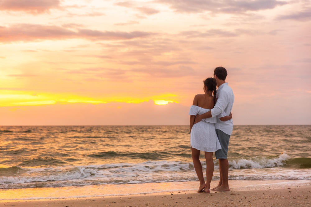 Winter in Florida, pretty couple at the beach watching the sunset