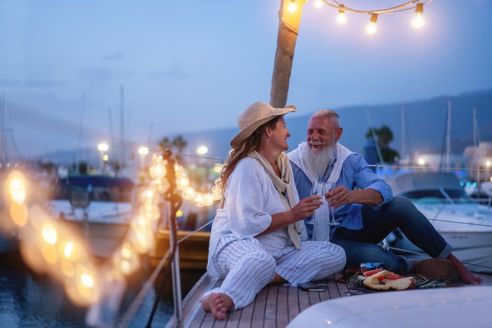 Winter in Florida, older couple on a boat in Florida enjoying a glass of wine and charcuterie board