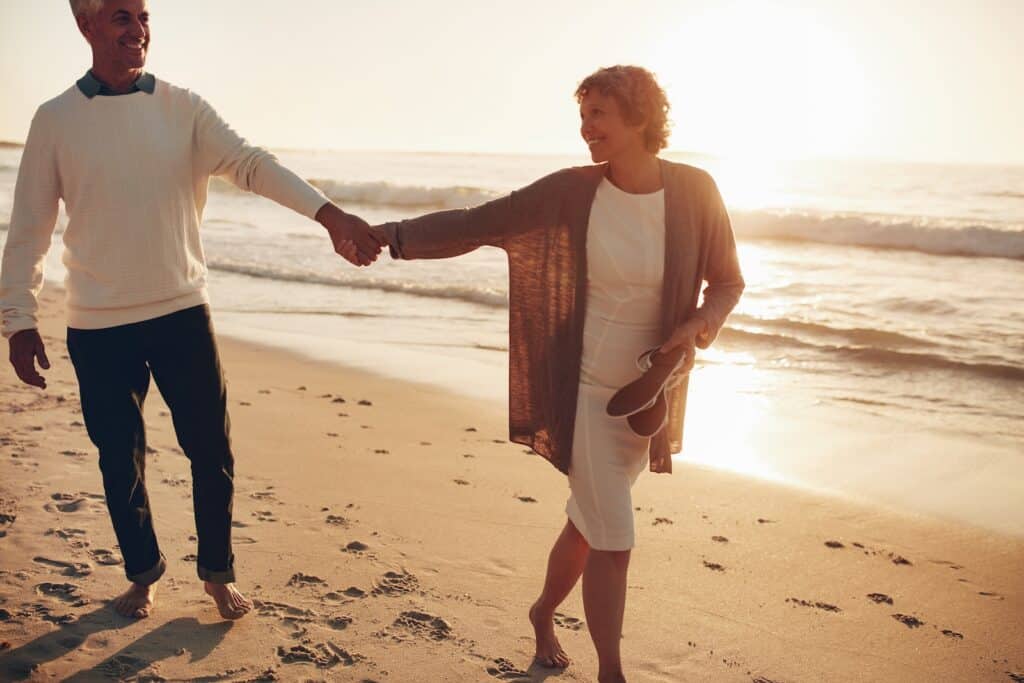 Couple walking along the beach on Anastasia Island at sunset.