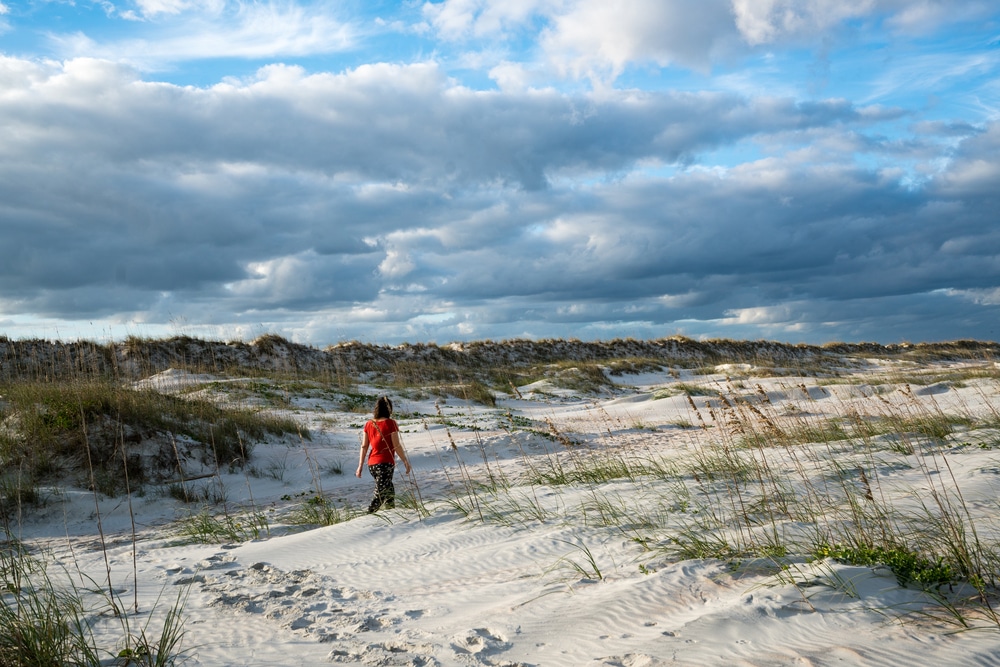 photo of a woman walking on Anastasia Island near our St. Augustine Bed and Breakfast