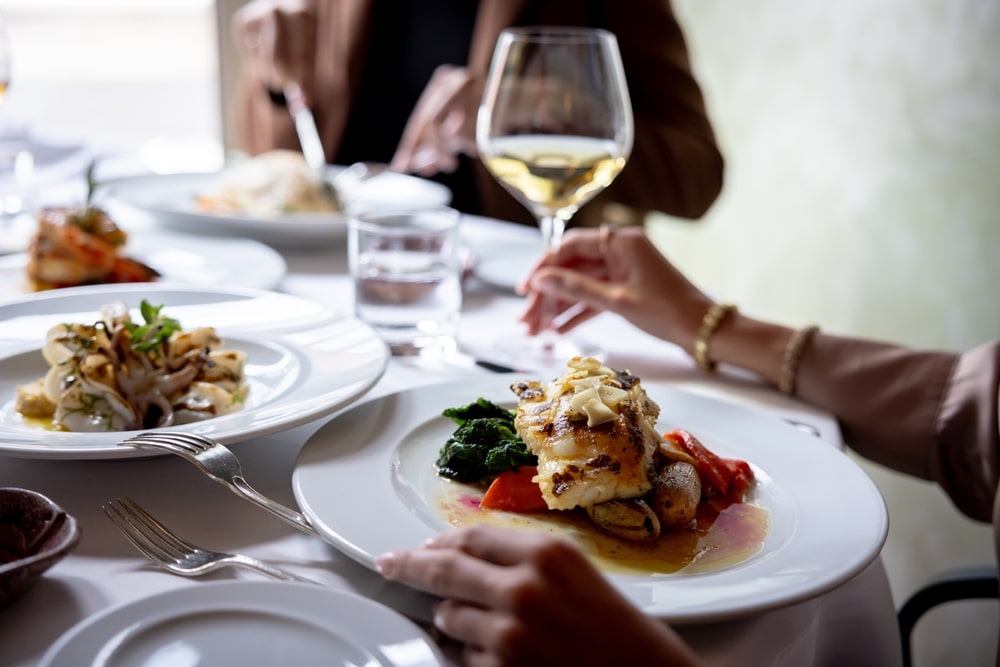 Restaurant plating with glasses of wine at one of the best places to eat in St. Augustine