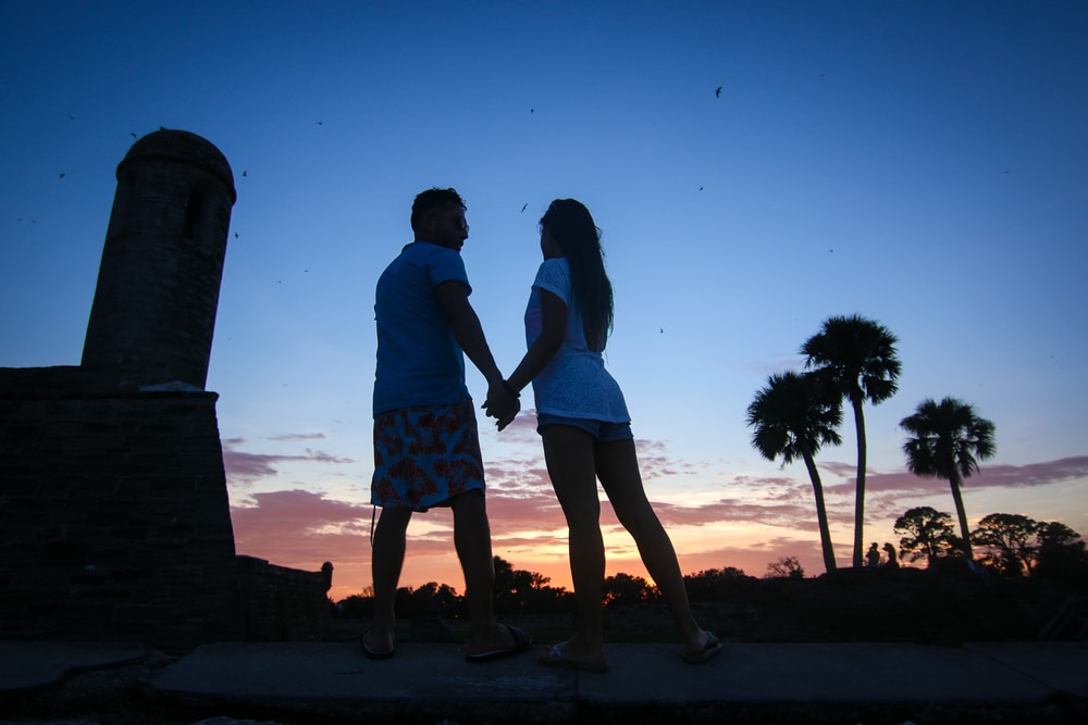 A Couple taking in a beautiful sunset - one of the most romantic things to do in St. Augustine