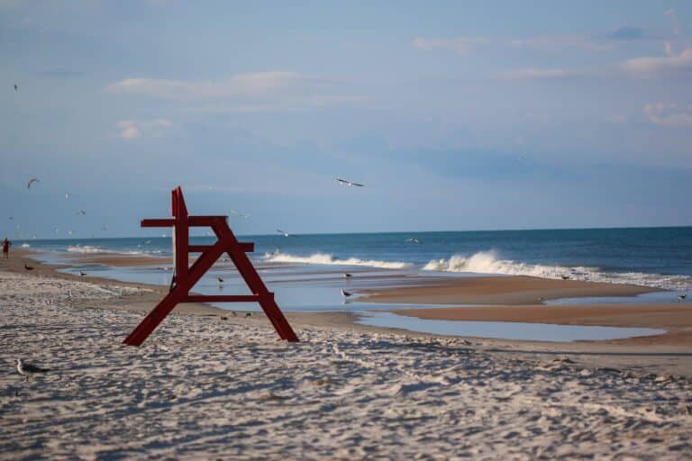 Lifeguard chair, Sand Pipers, and crashing waves on Anastasia Beach St. Augustine