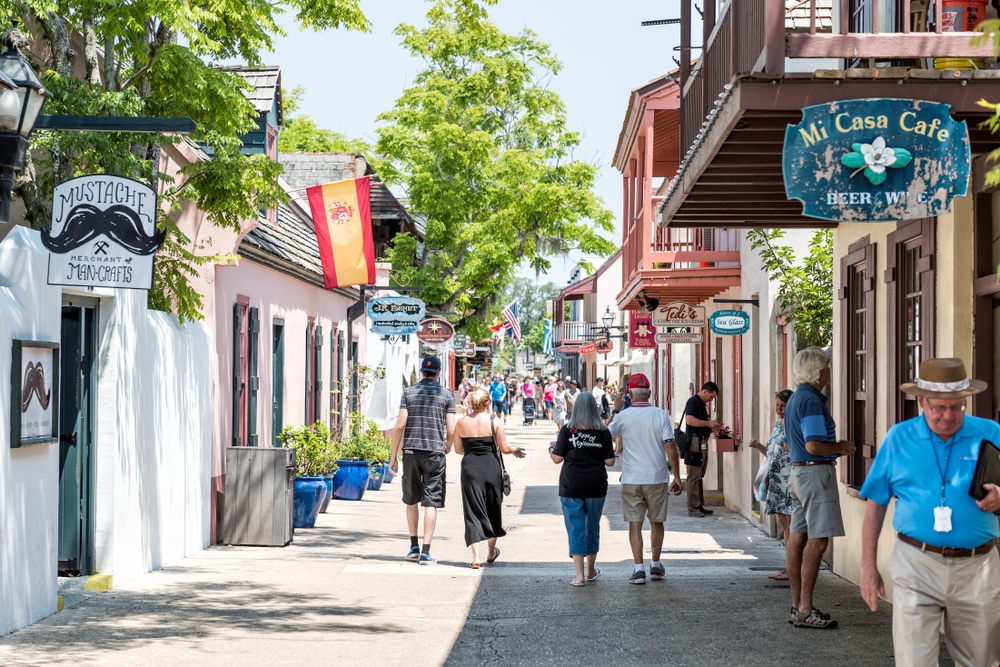 Two couples walking hand in hand through downtown St. Augustine